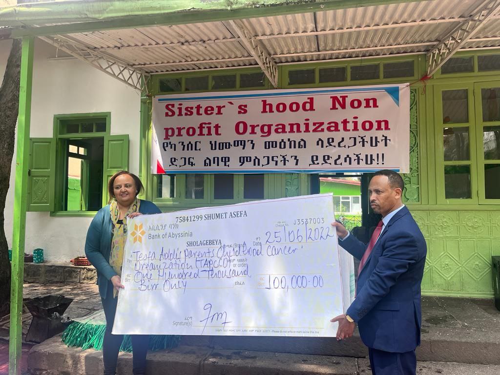 Sisterhood representatives presenting support to Tesfa Addis.